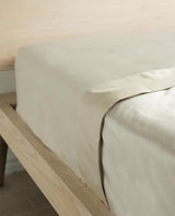 Close-up of dune-toned cotton percale showing the crisp weave
