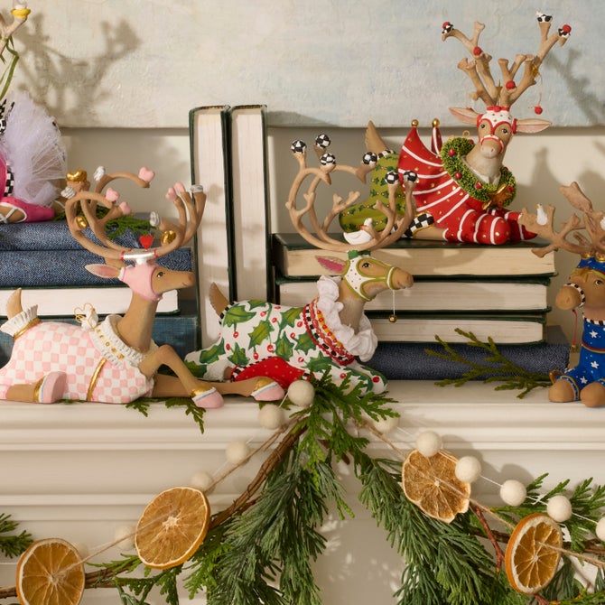 Patience Brewster Dash Away sitting reindeer on a mantel